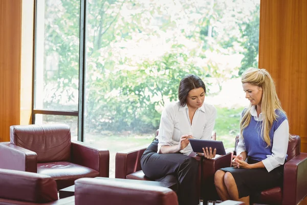 Businesswomen having a meeting and using tablet — Stock Photo, Image