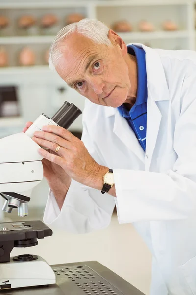 Senior scientist working with microscope — Stock Photo, Image