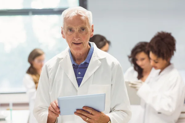 Science lecturer holding tablet pc in lab — Stock Photo, Image