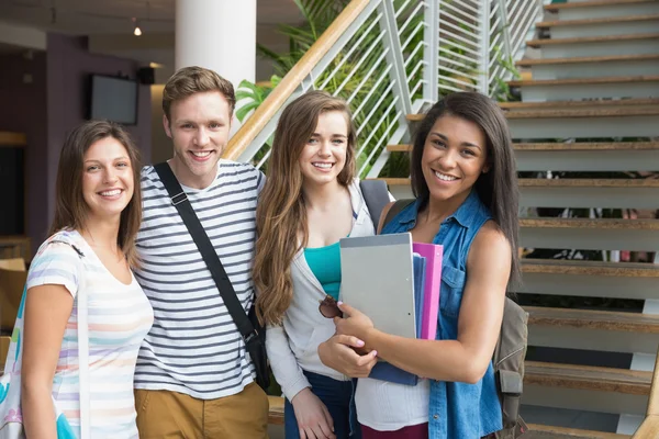 Smiling students looking at camera outside — Stock Photo, Image