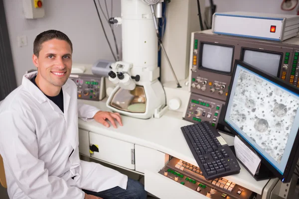 Studente di biochimica con grande microscopio e computer — Foto Stock