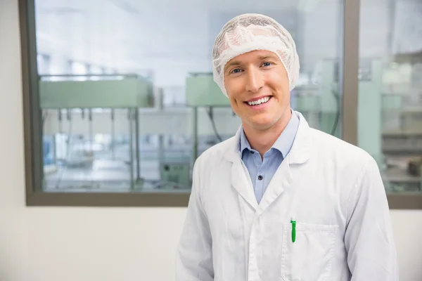 Happy pharmacist in a hairnet — Stock Photo, Image