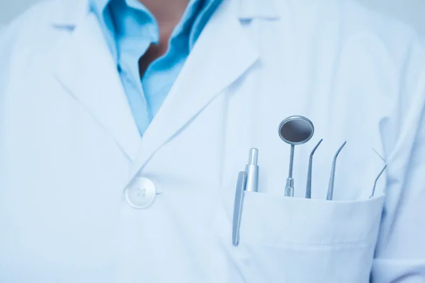 Mid section of dental tools in dentists pocket — Stock Photo, Image