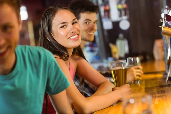 Smiling friends talking and drinking beer — Stock Photo, Image