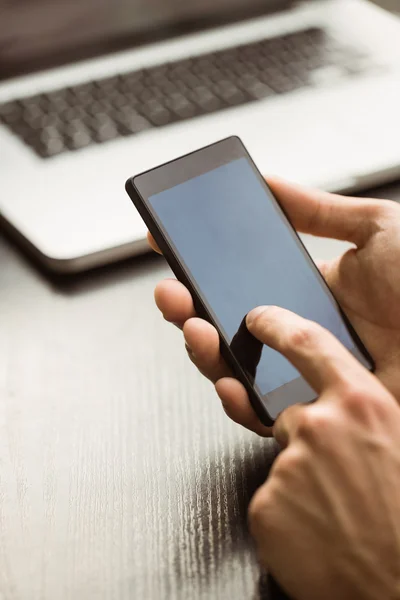 Student touching his mobile phone — Stock Photo, Image