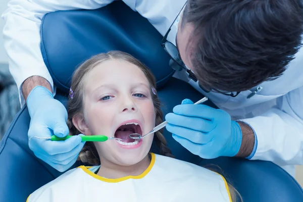 Dentista maschio esaminando i denti ragazze — Foto Stock