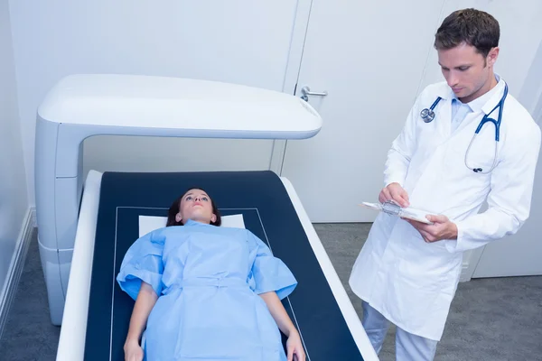 Focused doctor doing a radiography on a patient — Stock Photo, Image