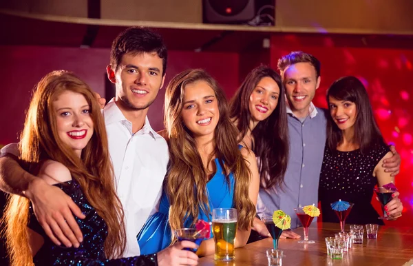 Happy friends on a night out together — Stock Photo, Image