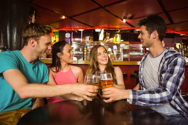 Portrait of happy friends toasting with drink and beer — Stock Photo, Image