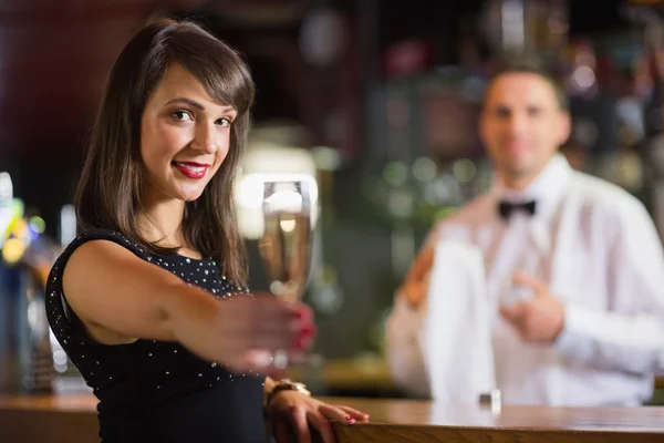 Morena bonita sorrindo para a câmera com champanhe — Fotografia de Stock