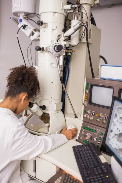 Biochemistry students using large microscope and computer — Stock Photo, Image