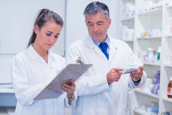 Pharmacist looking a medication for a prescription — Stock Photo, Image