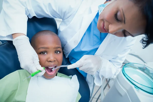 Female dentist examining boys teeth — Stock Photo, Image