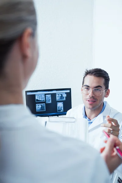 Dentists discussing reports — Stock Photo, Image