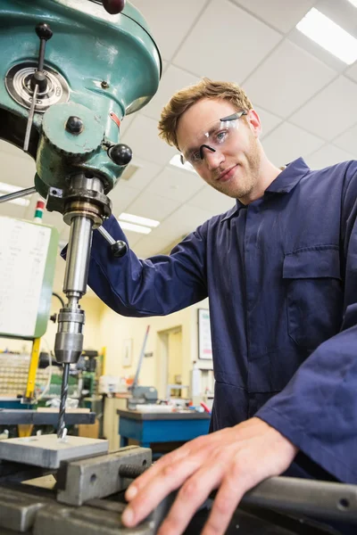Engineering student using large drill — Stock Photo, Image