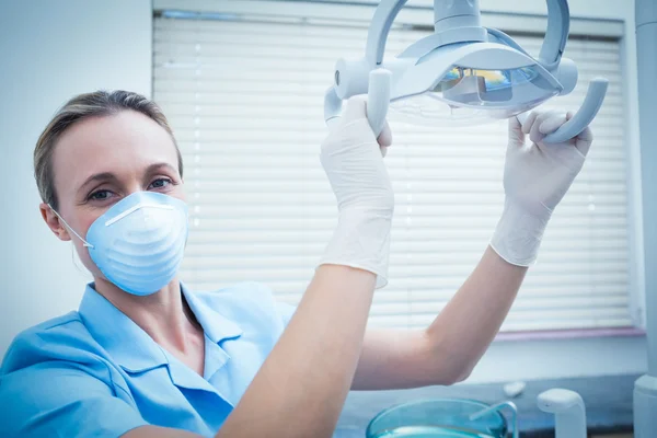 Retrato de dentista ajustando a luz — Fotografia de Stock