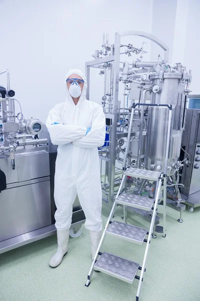 Scientist in protective suit standing with arms crossed — Stock Photo, Image