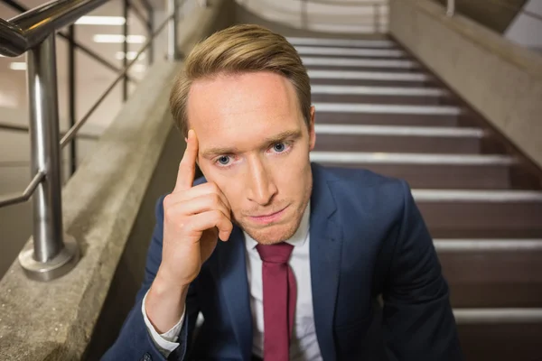 Stressed businessman sitting on steps — Stock Photo, Image