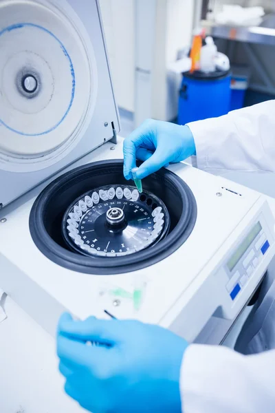 Close up of a chemist using a centrifuge — Stock Photo, Image