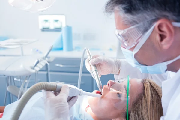 Dentist examining his patient Royalty Free Stock Images