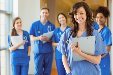 Medical students smiling at the camera clipart