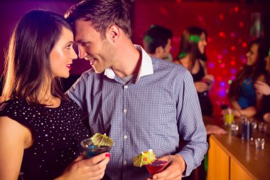 Cute couple drinking cocktails together clipart