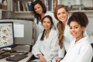 Science students smiling at camera clipart