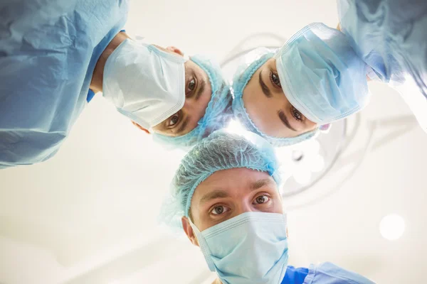 Young surgeons looking down at camera — Stock Photo, Image