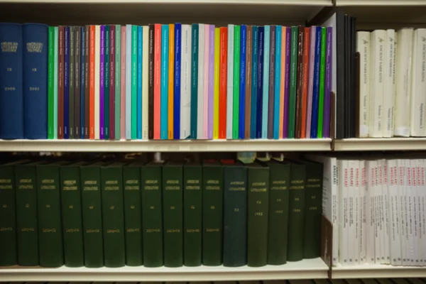 Volumes of books on bookshelf in library — Stock Photo, Image