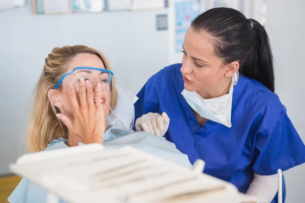Paciente y dentista hablando de su dolor de muelas —  Fotos de Stock