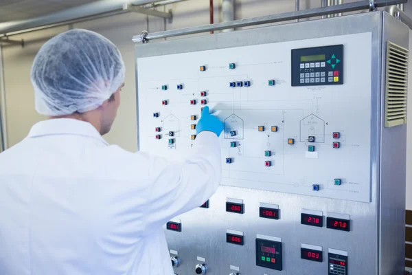 Scientist using the machine and pressing on buttons — Stock Photo, Image