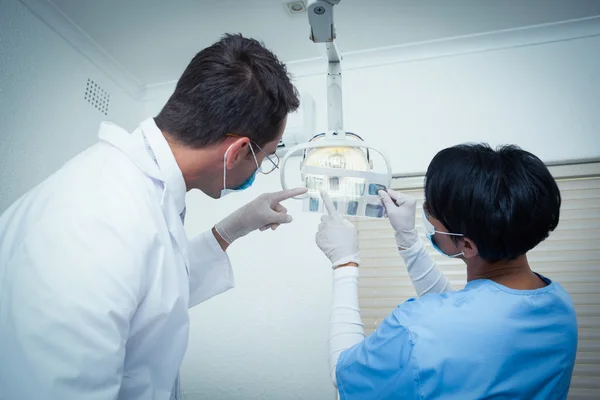 Dentists looking at x-ray — Stock Photo, Image