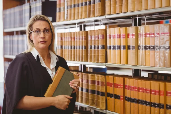 Serious lawyer holding a book — Stock Photo, Image