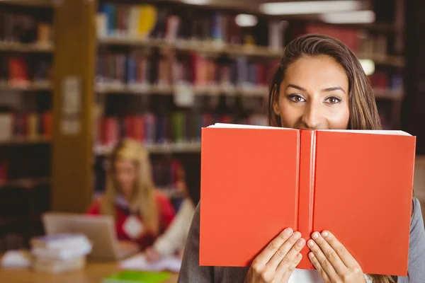 Pretty brunette student holding book — Stock Photo, Image