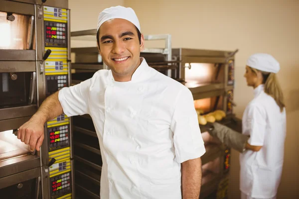 Knappe baker glimlachen op camera — Stockfoto