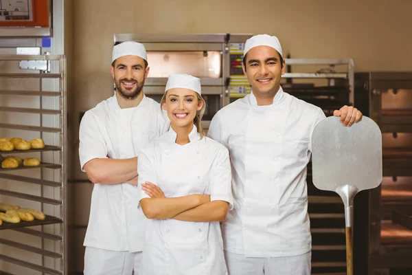 Team of bakers smiling at camera — Stock Photo, Image