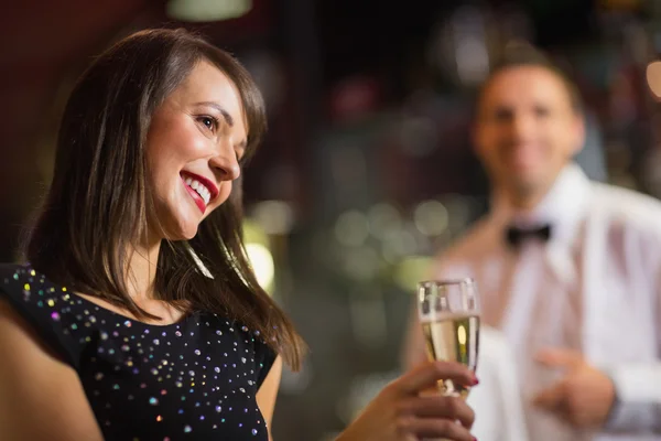Ładna brunetka uśmiechający się z szampanem — Zdjęcie stockowe