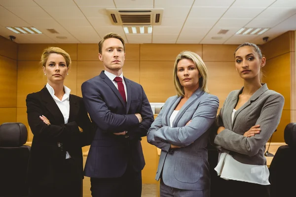 Retrato de cuatro abogados bien vestidos con los brazos cruzados —  Fotos de Stock