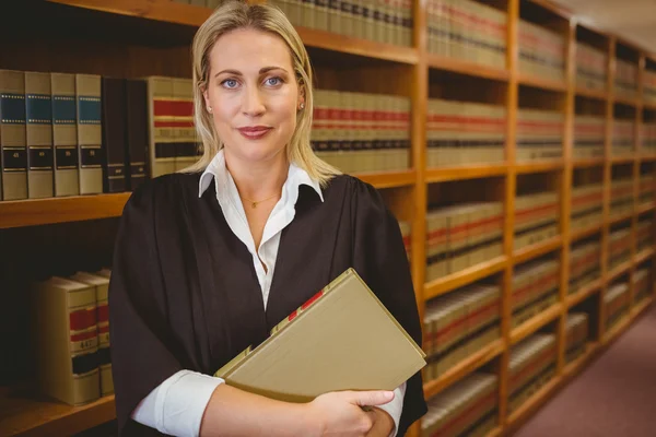 Serious lawyer holding a file while standing — Stock Photo, Image