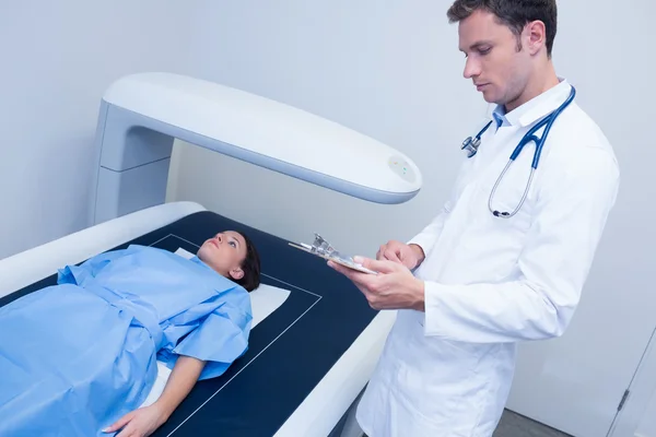 Focused doctor doing a radiography on a patient — Stock Photo, Image