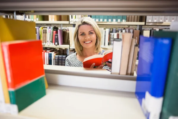 Mature student reading a book in library — Stock Photo, Image