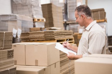 Warehouse worker checking his list clipart
