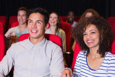 Young couple watching a film clipart