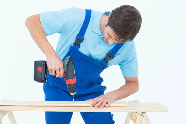 Carpenter using drill machine on wood — Stock Photo, Image