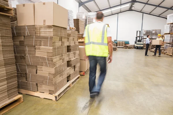 Blurred worker walking in warehouse — Stock Photo, Image