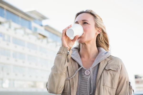 Blonde drinking of disposable cup — Stock Photo, Image