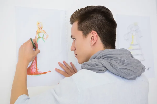 Fashion student drawing pictures on paper — Stock Photo, Image