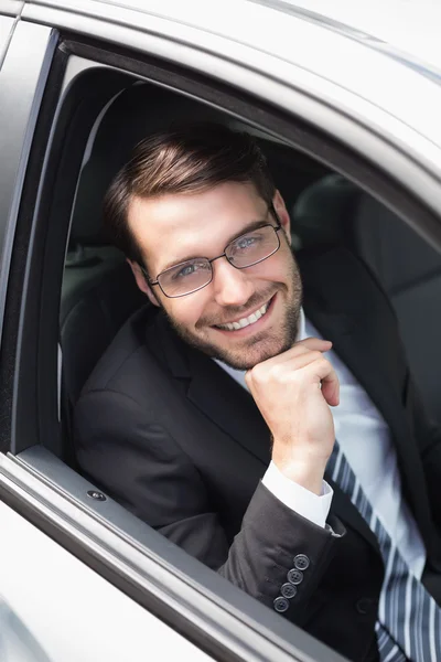 Happy businessman in the drivers seat — Stock Photo, Image