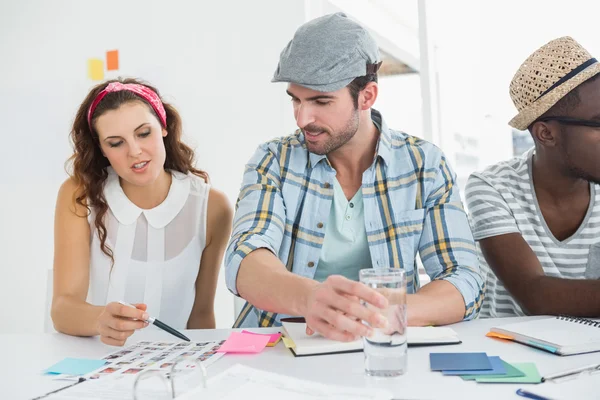 Cheerful colleagues editing photos — Stock Photo, Image