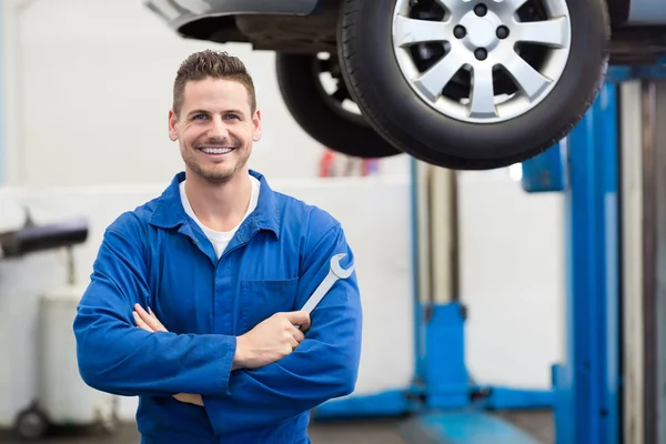 Mechanic smiling holding tool — Stock Photo, Image